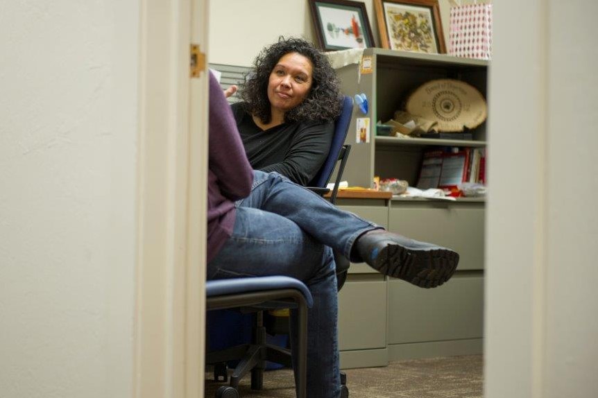 Director of the Native Nest Michelle Villegas-Frazier meets with a student in her office.